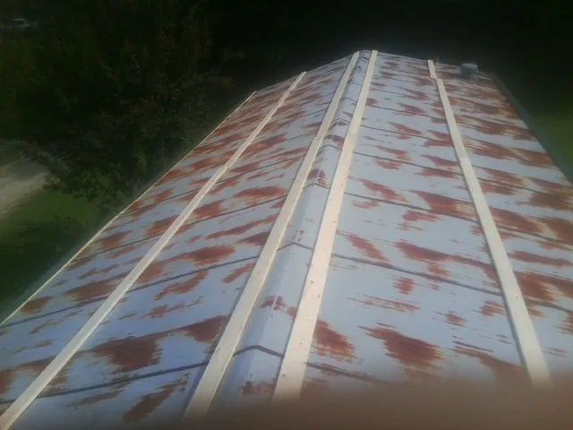 Rusted metal roof panels with new wood purlins before replacement — Storm Damage Roof Repair in Lodi by Roofing Brothers